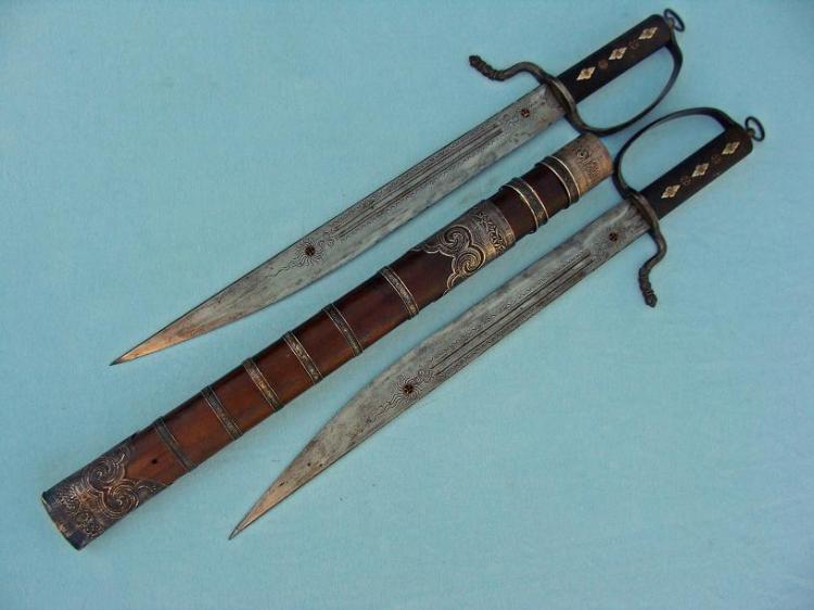 This set of Butterfly Swords has a number of unusual features.  Perhaps the most striking are its wood (rather than leather) scabbard and high degree on ornamentation.  These probably date to the late 19th century and are 49 cm in length.   Photo courtesy of http://www.swordsantiqueweapons.com.