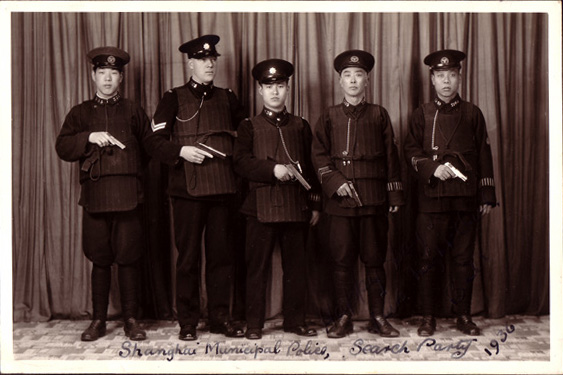 An "entry team" of officers in the Shanghai Foreign Concession, trained and led by a British officer. The police needed serious training and firepower to stand up to the strong criminal gangs that controlled much of the city. Photographer is unknown.