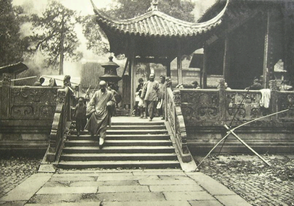 A Buddhist monk and novice leaving a the temple.  Probably Shanghai, circa 1900. 
