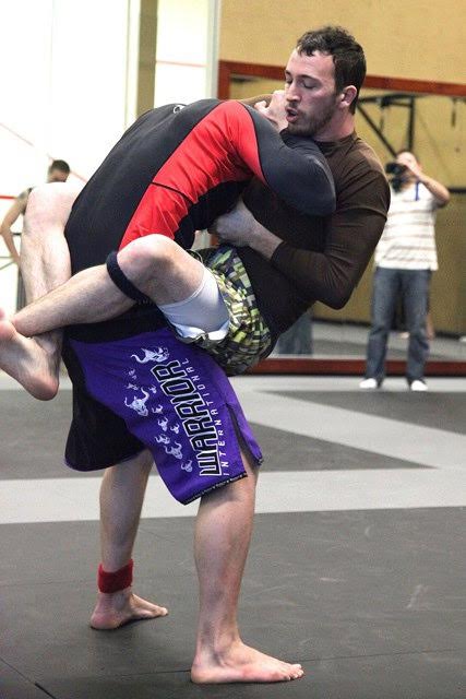 Prof. Kyle Green competing in a grappling tournament.